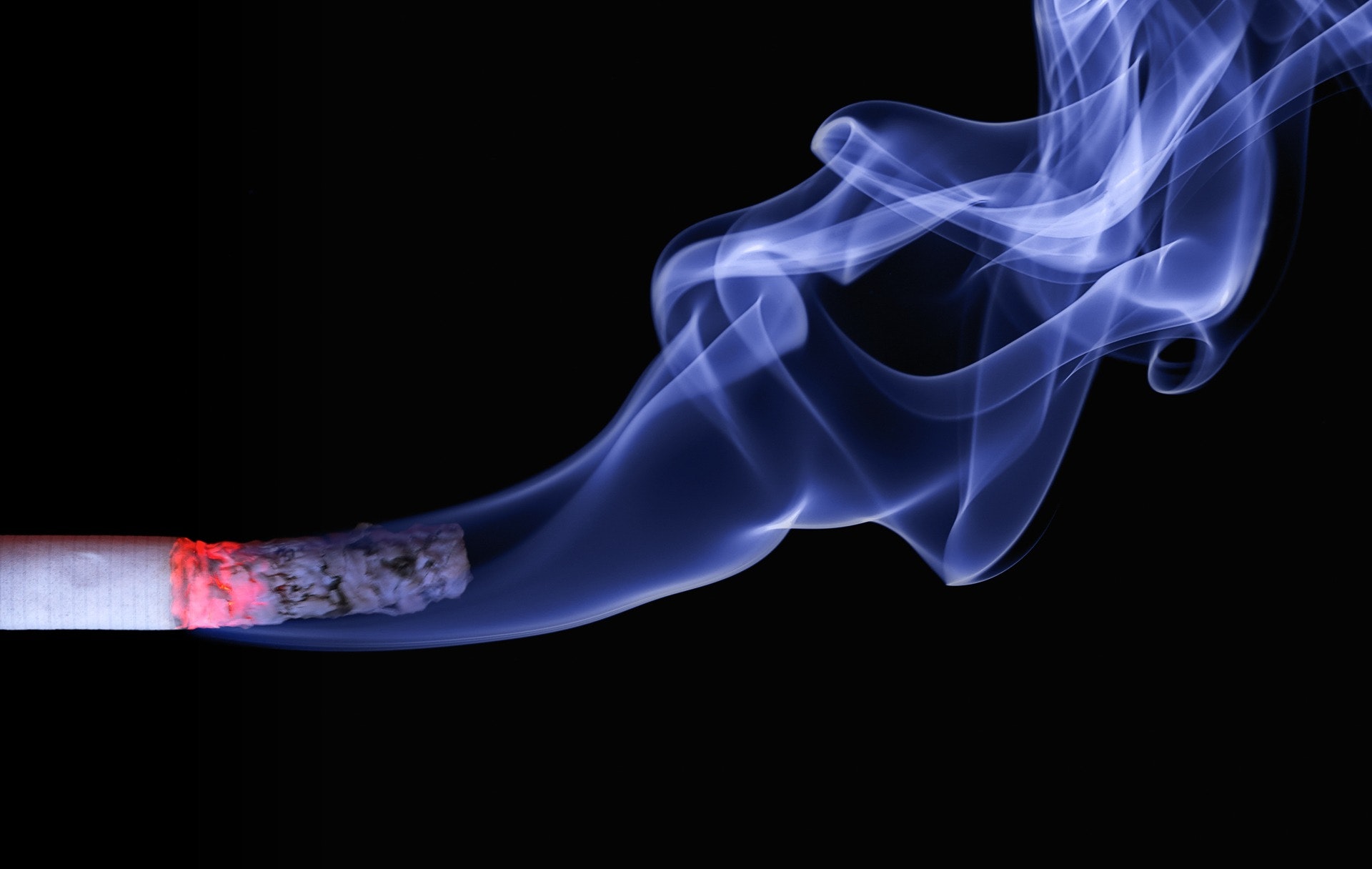 Image of cigarette burning with smoke 