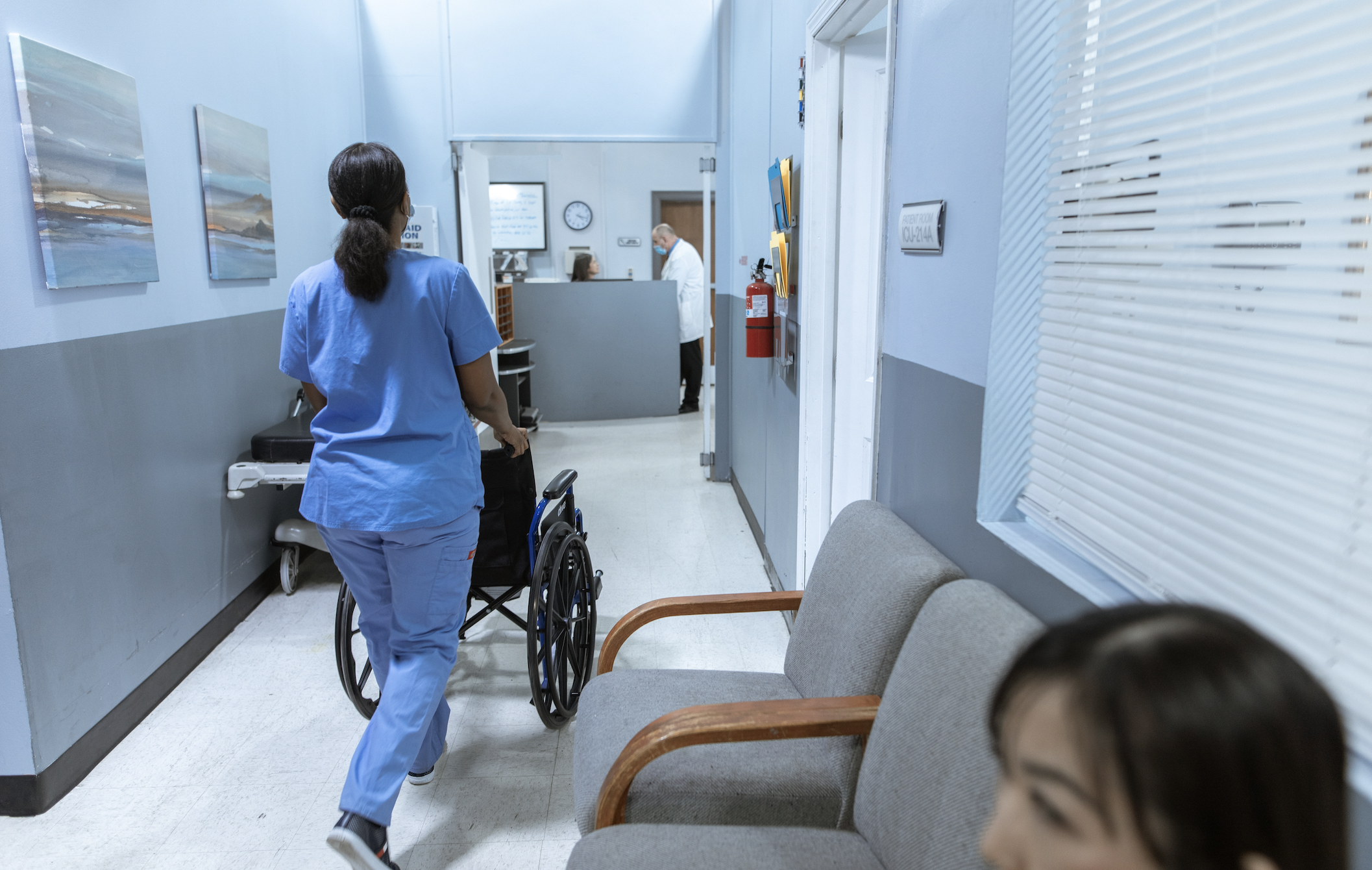 Nurse walking down hospital hallway