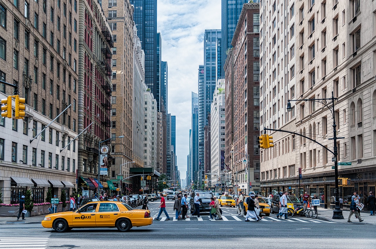 Pedestrians crossing the street in a busy New York City