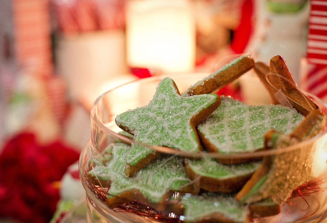 christmas cookies in the forefront with a blurred background of holiday decorations