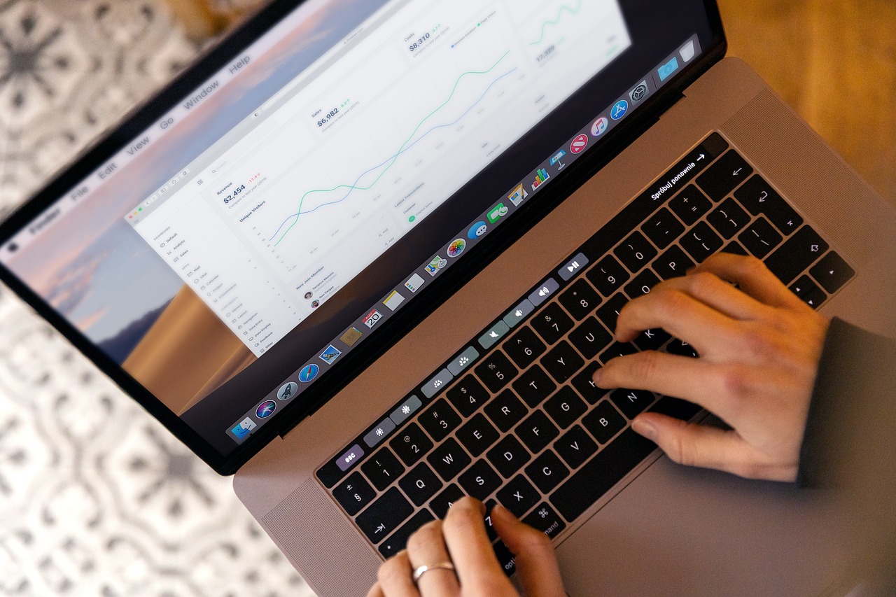 birds eye view of an open laptop with hands on the keyboard