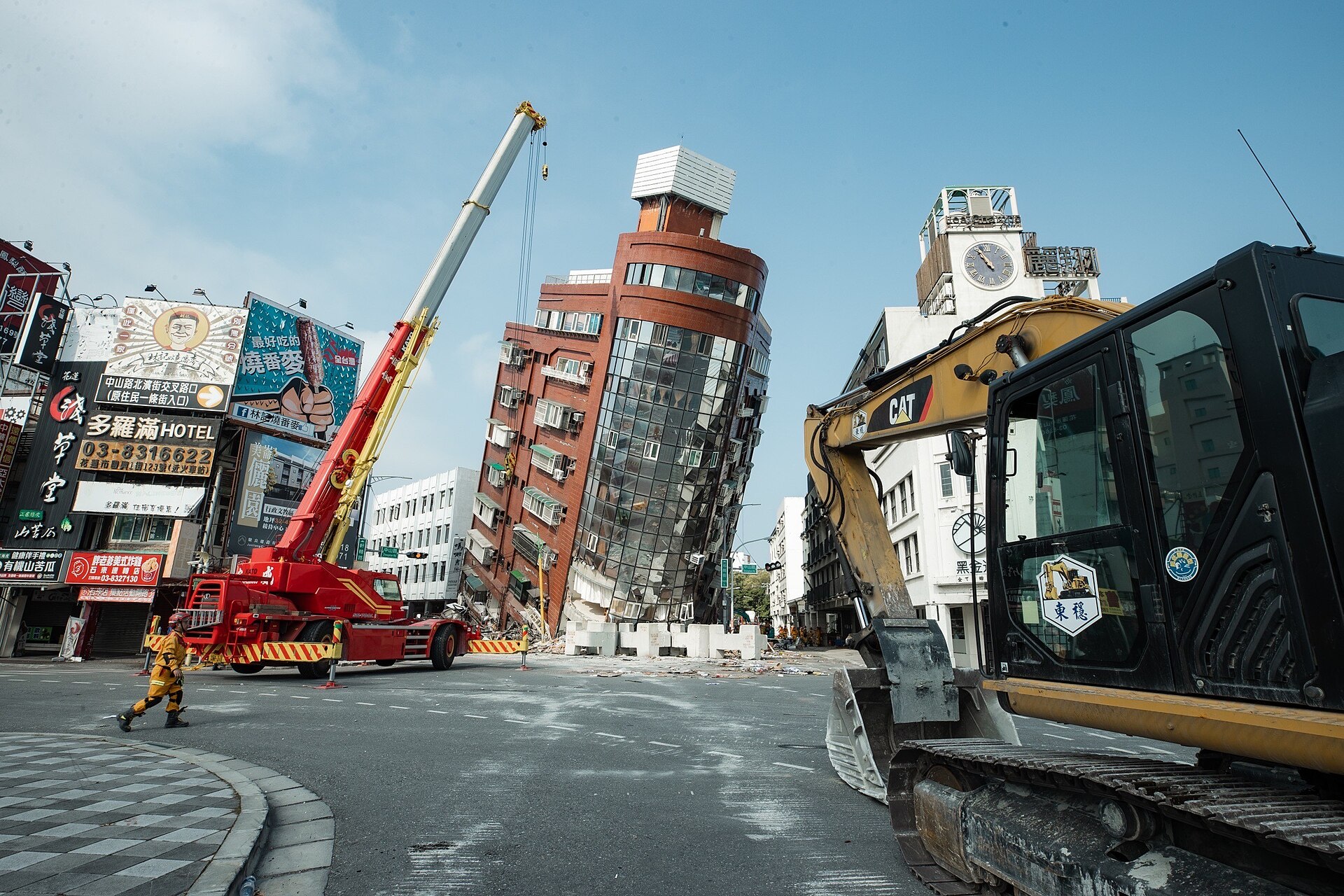 Damaged buildings and rescue worker on a street near earthquake damage in Taiwan