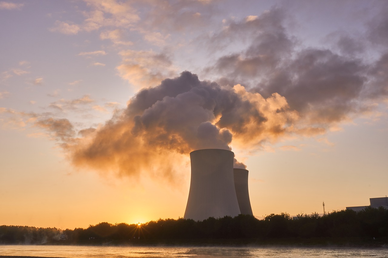 Nuclear power plant with smoke going into the evening sky