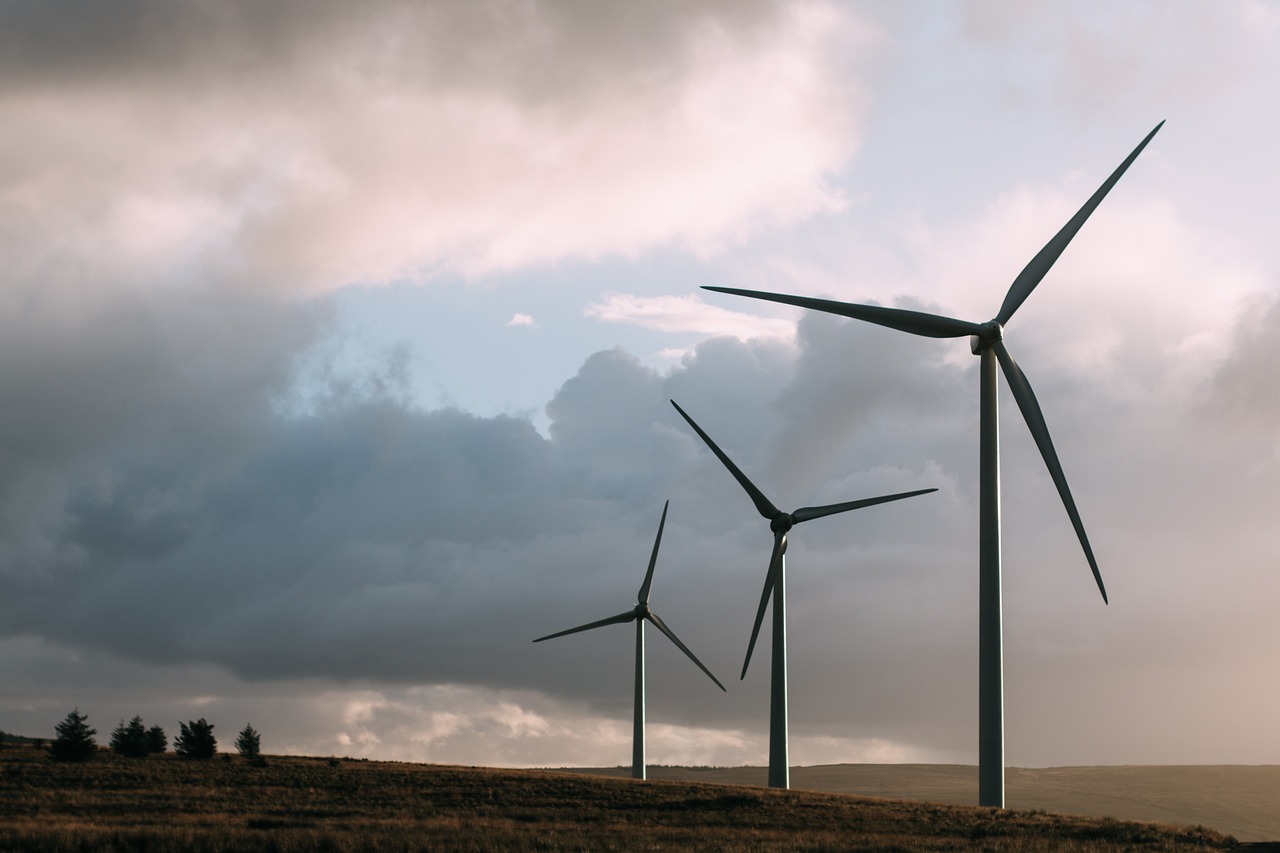 Wind turbines against a cloudy, dark sky