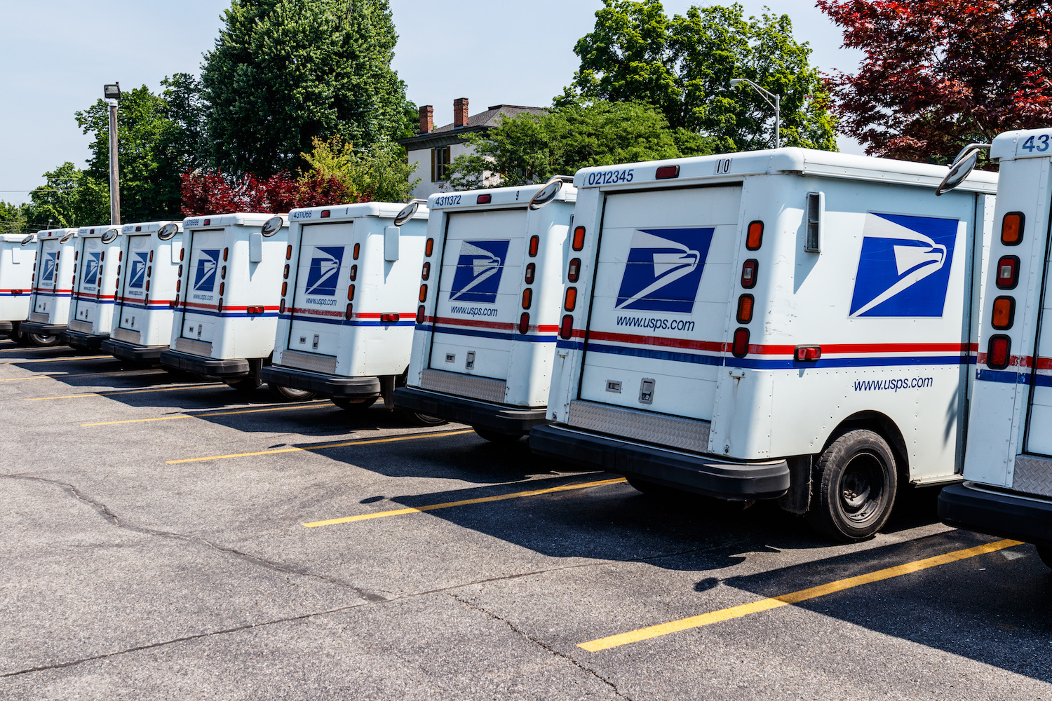 US Postal Service trucks parked in a lot