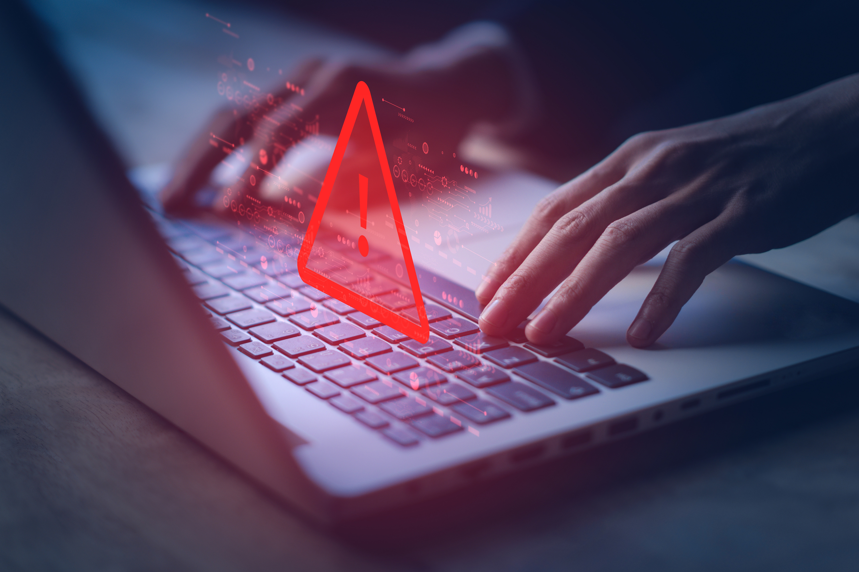 keyboard with a red triangle above to illustrate a scam