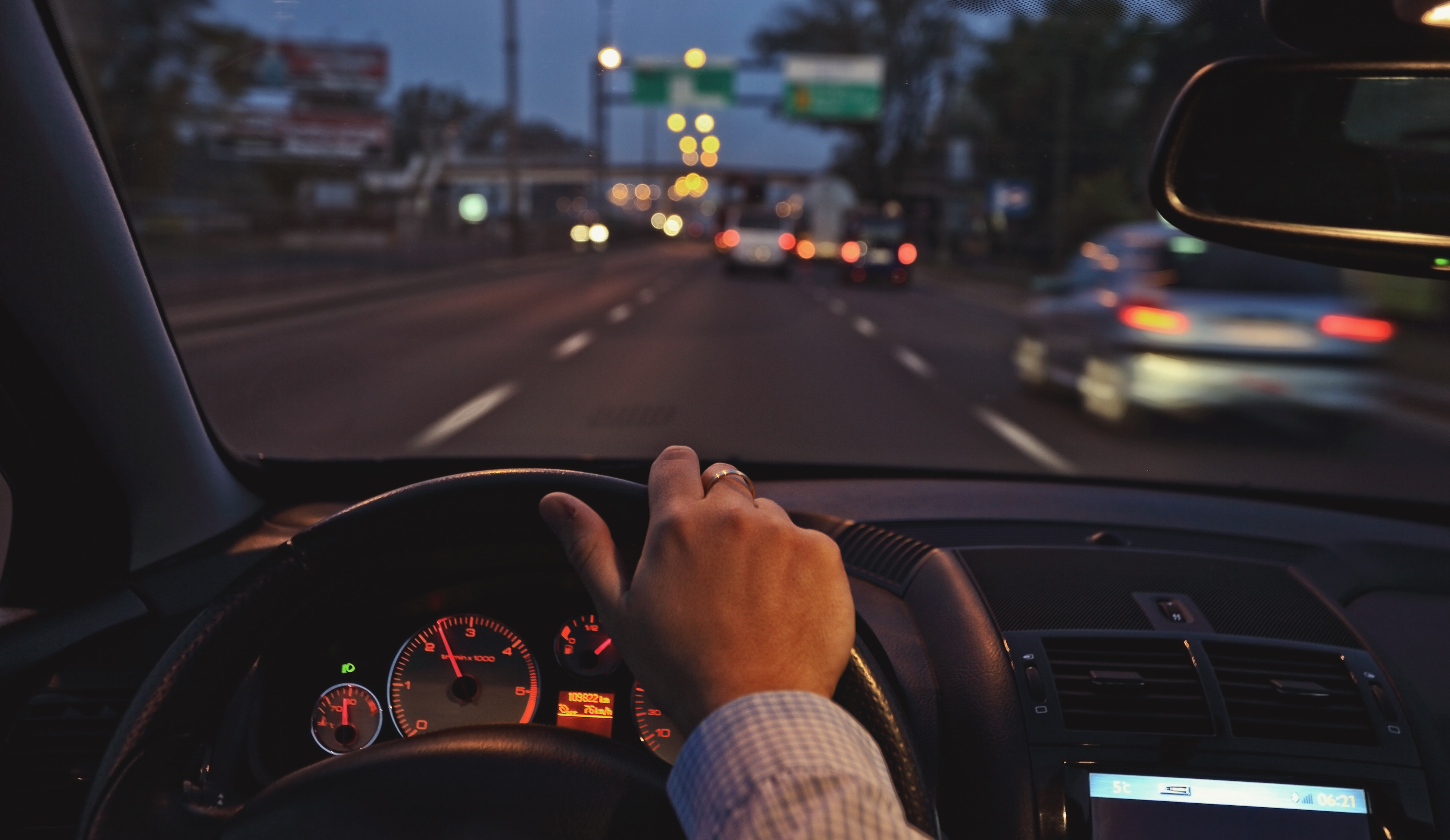 View from a steering wheel driving on a road
