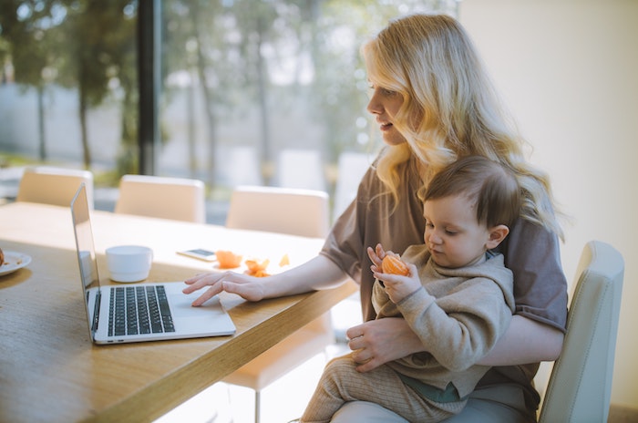 Woman with baby at laptop