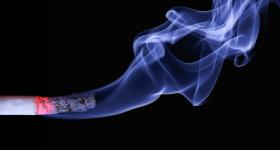 Image of cigarette burning with smoke 