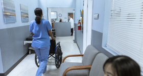 Nurse walking down hospital hallway