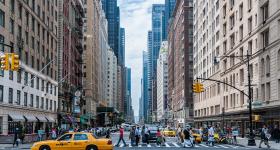 Pedestrians crossing the street in a busy New York City