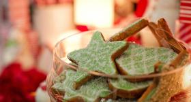 christmas cookies in the forefront with a blurred background of holiday decorations