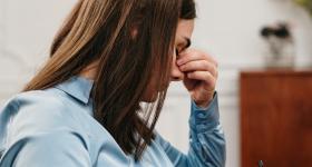 stock photo of a woman with her head in her hand