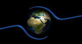 globe against a black backdrop and two blue lines circling the world