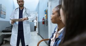 doctor speaking to two patients