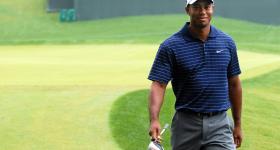 Tiger Woods walking on a golf green