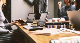 file shot of people at a table in an office setting