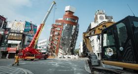 Damaged buildings and rescue worker on a street near earthquake damage in Taiwan