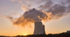 Nuclear power plant with smoke going into the evening sky